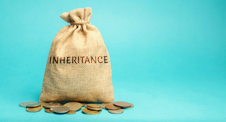 Money bag with the word Inheritance. Separation of inheritance between relatives or transfer of...