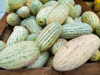 ripe juicy sweet melons on supermarket counter