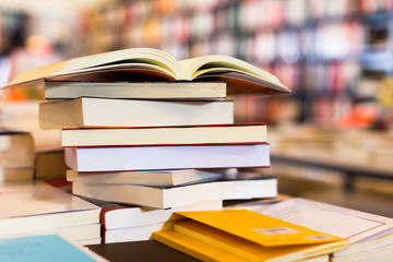 stack of books lying on table in bookstore