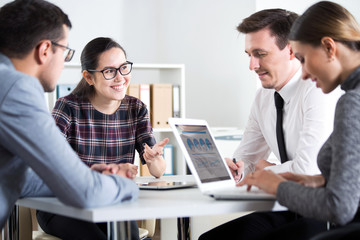 Businesswoman explains to colleagues a new project