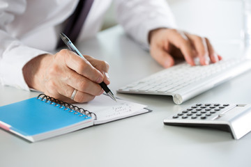 Close-up of businessman hands typing on the keyboard in an office