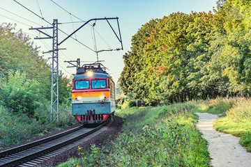 Freight train moves on the rural landscape background.