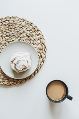 Morning breakfast with coffee and dessert on white table. Flat lay, top view minimal food concept.