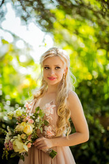 happy bride in pink dress with flowers