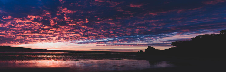 Fototapeta na wymiar A beautiful transition between daylight and moonlight over an Australian beach.