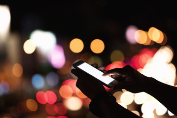 Close up of man hand using mobile phone in the street