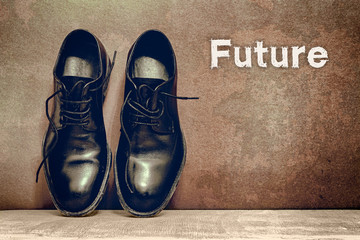 Future on brown board and work shoes on wooden floor