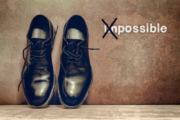 Possible on brown board and work shoes on wooden floor