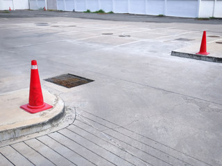 Plastic Orange Traffic Cones at Entrance of Empty Outdoor Parking Lot
