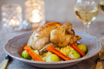 Whole roast poussin with brussel sprouts and carrots in cider gravy