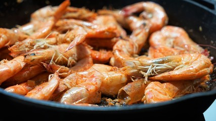 shrimps on cast-iron pan close up