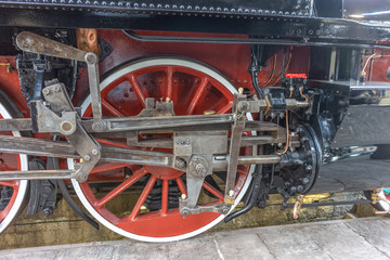 Fototapeta na wymiar Restored wheels of an ancient steam train