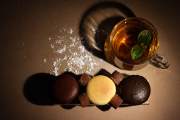 Cheese cakes,tea cup and sugarcane with wood on paper. Sweetmeat concept. Original, choco and macha flavor.