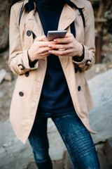 Woman in a beige coat and jeans
