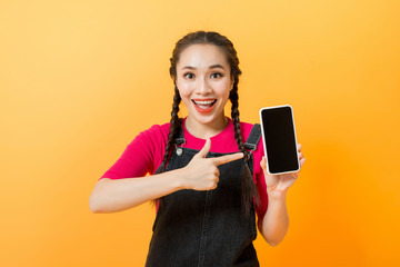 Pretty asian woman holding smartphone and pointing finger to the smartphone.