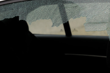 Broken car window and cracked glass of a automobile