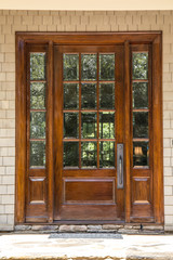dark wood stained custom door with windows outside of a large custom home