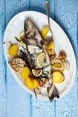 Whole sea bass baked with lemon and herbs