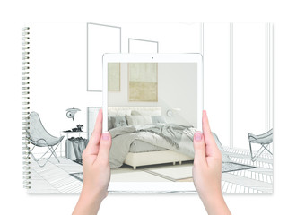 Hands holding tablet showing bedroom, notebook with blueprint sketch in the background, augmented...