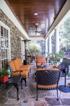 Outdoor Stone Patio Porch Of Large Home Estate With Orange Rust Colorseating