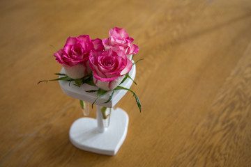 Flat lay. Top view. Heart shape of pink rose petals. Vintage photography with rose petals, Valentine's day with beautiful rose petals