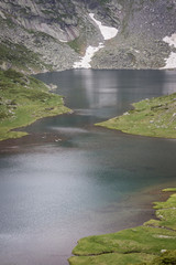 Vertical view of beautiful Twin glacial lake on Rila mountain in Bulgaria and rocky cliffs