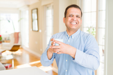 Middle age man enjoying and drinking a cup of coffee at home