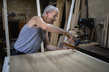 Old carpenter in his workshop