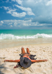 Fototapeta na wymiar woman sunbathing on the tropical beach