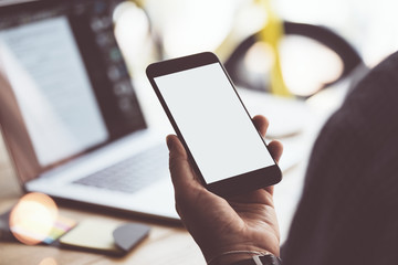 Close up of male hands with smartphone. Blank screen, Mock-up, copyspace ready for text or design