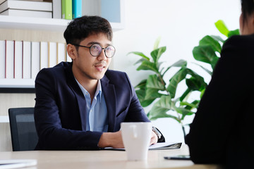 Young asian businessman smiling at business meeting, job interview, in office, business people, office lifestyle concept