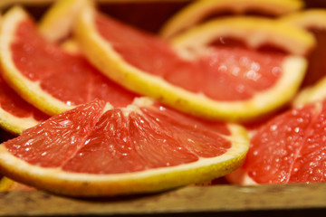Grapefruit slices in a wooden bowl ready to be used in a cocktail