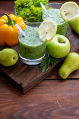 Diet drink, smoothie. Green color. Body cleansing. Diet. Nearby are orange pumpkin, pears, apple, mint leaves, pepper. Lobules of Lemon. A bunch of white grapes. Healthy eating Light breakfast. 
