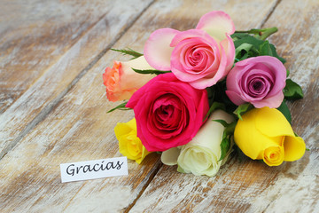 Gracias (thank you in Spanish) card with colorful rose bouquet on rustic wood