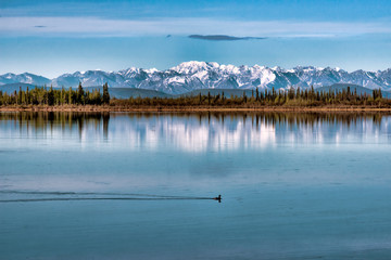 Rocky Mountains in Alaska Reflected in Lake