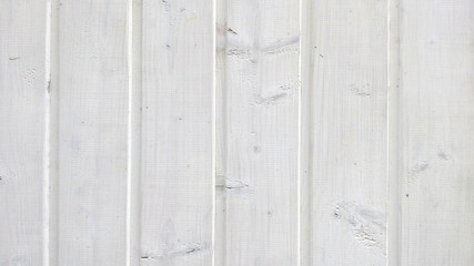 Texture of old wood planks with peeling white paint