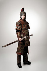 Adult male wearing very old armor.