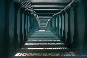 long steel corridor under bridge  
