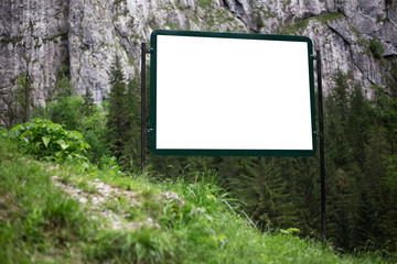 Outdoor billboard blank for advertising poster with mockup in forest.