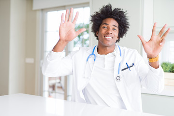 African American doctor man at the clinic showing and pointing up with fingers number nine while...