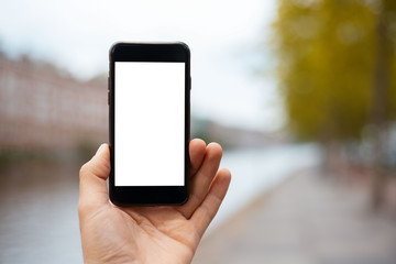 Close-up of smartphone, with mock-up in hand of girl. Autumn day.