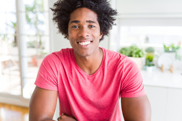 African American business man wearing pink casual t-shirt with a happy and cool smile on face. Lucky person.
