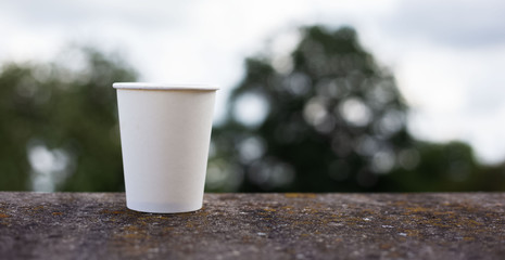 Close-up of white paper glass with mockup
