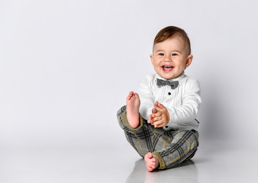 Happy baby. Little boy in a white shirt and bow tie. Children portrait. Stylish man in fashionable a bow-tie.