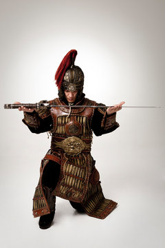 Adult male wearing very old armor.