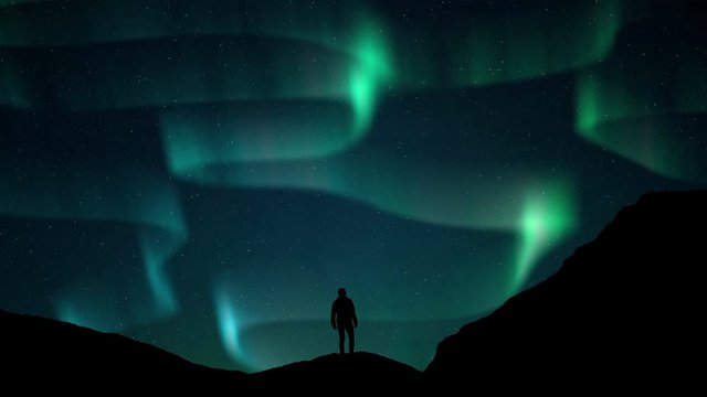 Aurora Borealis Green fluor Northern Lights and silhouette man watching. Winter landscape with polar weather in Arctic, Norway,Canada,Finland,Iceland, Sweden. Starry night sky scenery background 4k