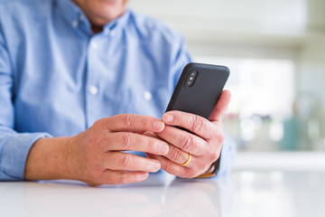 Close up of man hands using smartphone over white table