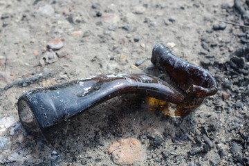 burnt and melted glass bottle. ecycling of glass bottle processing waste