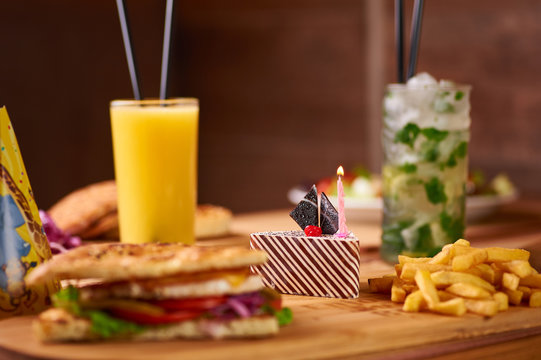 fast food served table for company of friends. burger, french fries at birthday served table.