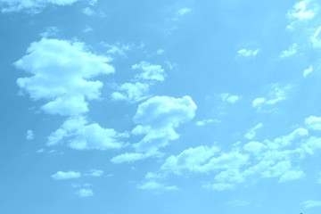 White clouds in a blue sky in a cloudy summer day